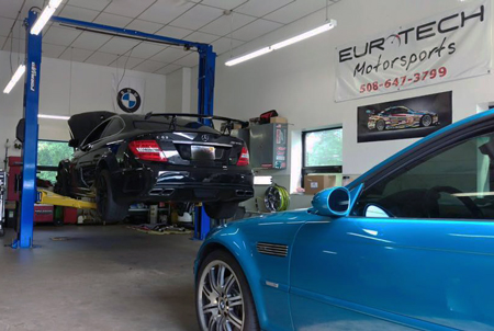 Mercedes C63 AMG Black Series and BMW E46 M3 in garage.