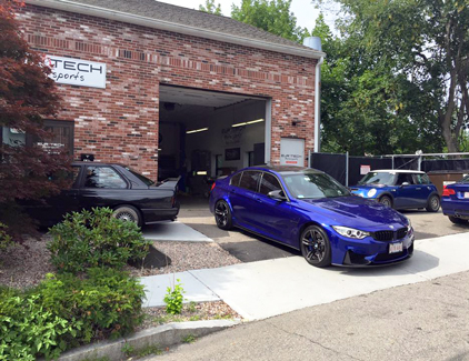 Assorted BMWs outside the garage.
